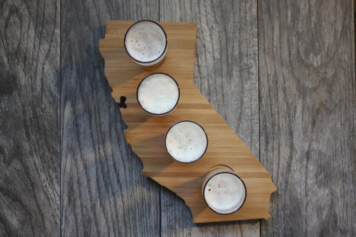 California shaped bamboo beer flight board with four tasting glasses